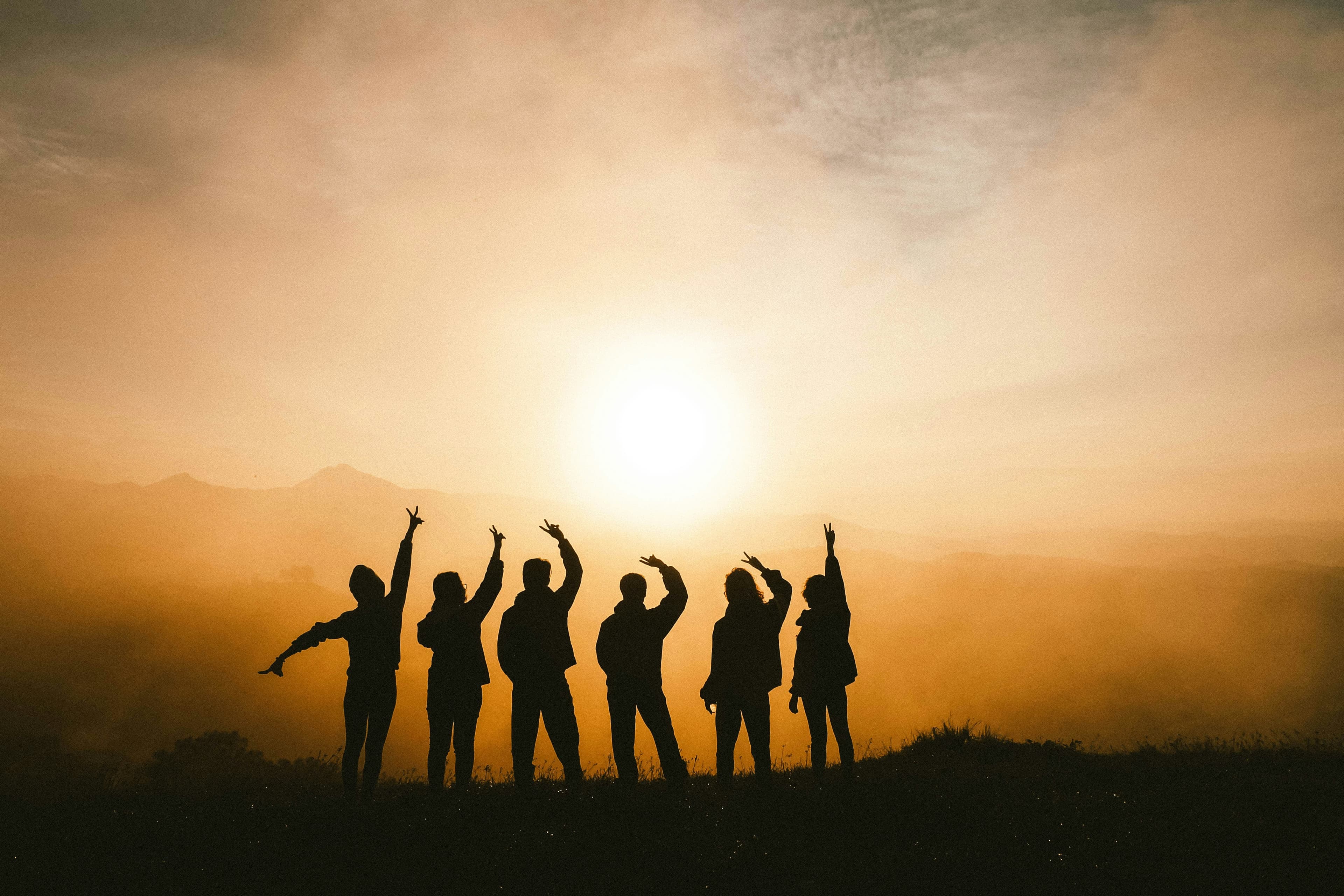 Mountain silhouettes at sunset with hikers